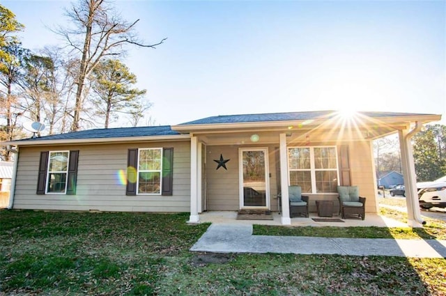 view of front of house featuring a front yard and a patio