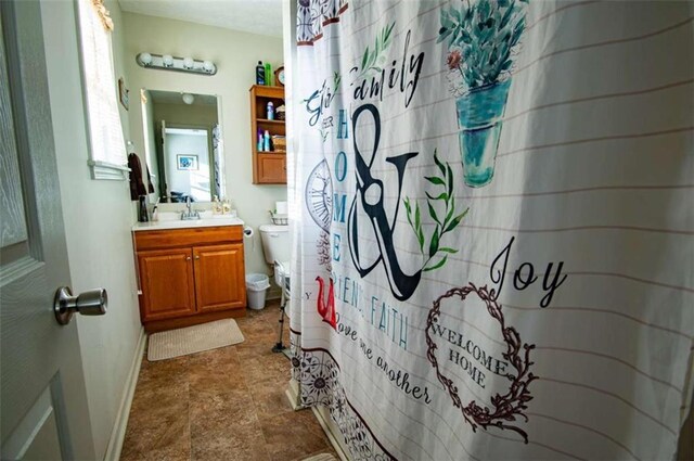 bathroom with a shower with shower curtain, baseboards, toilet, and vanity