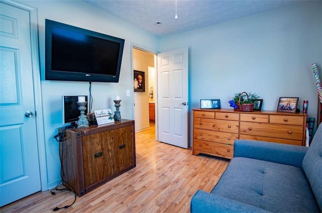 living area featuring a textured ceiling and light wood finished floors