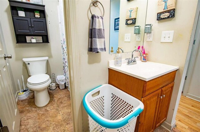 bathroom with toilet and vanity