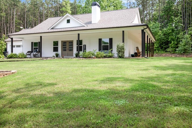 594 Maner Rd, Rockmart, GA 30153 - view of front of property with a garage, a front yard, a chimney, and french doors