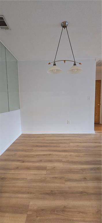 spare room with light wood finished floors and baseboards