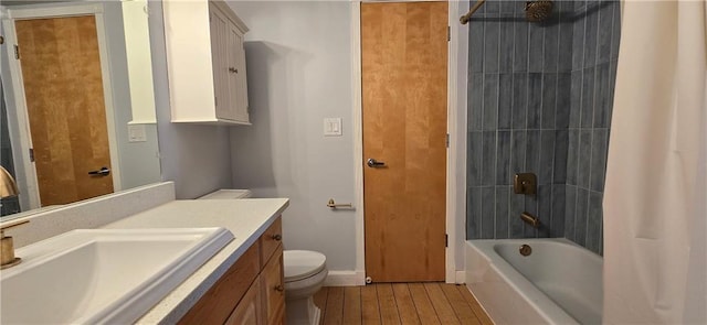 full bathroom with toilet, vanity, shower / bathtub combination with curtain, wood finished floors, and baseboards