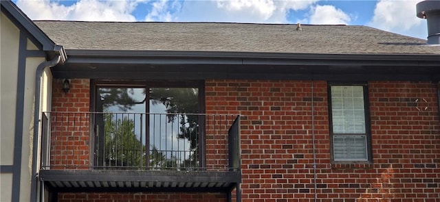 exterior view of brick siding, a downspout, and gutters