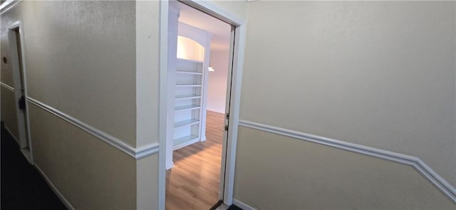 corridor featuring wood finished floors
