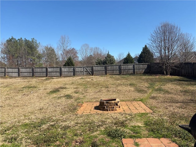 view of yard with a fire pit and a fenced backyard