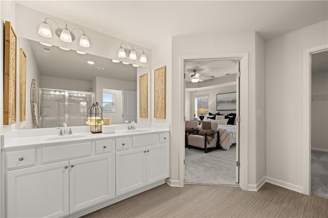 ensuite bathroom with a sink, a shower stall, ensuite bathroom, and double vanity