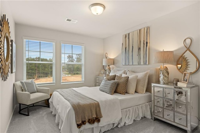 carpeted bedroom with baseboards and visible vents