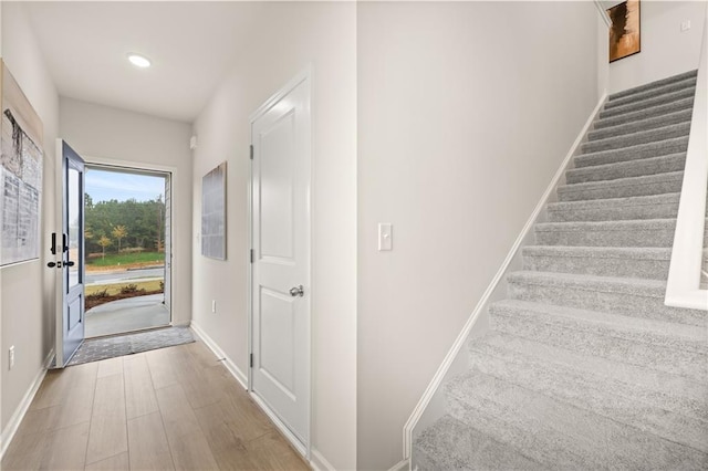 interior space featuring baseboards, wood finished floors, and recessed lighting