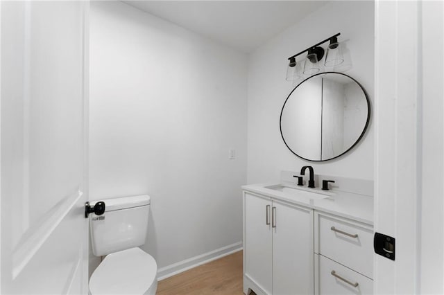 44 Crayton St, Rockmart, GA 30153 - bathroom with vanity, toilet, wood finished floors, and baseboards