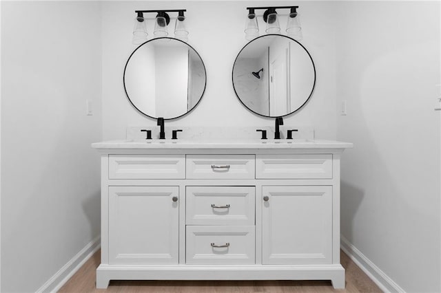 44 Crayton St, Rockmart, GA 30153 - full bathroom with double vanity, baseboards, and wood finished floors