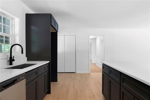 44 Crayton St, Rockmart, GA 30153 - kitchen with stainless steel dishwasher, a sink, light countertops, and light wood finished floors
