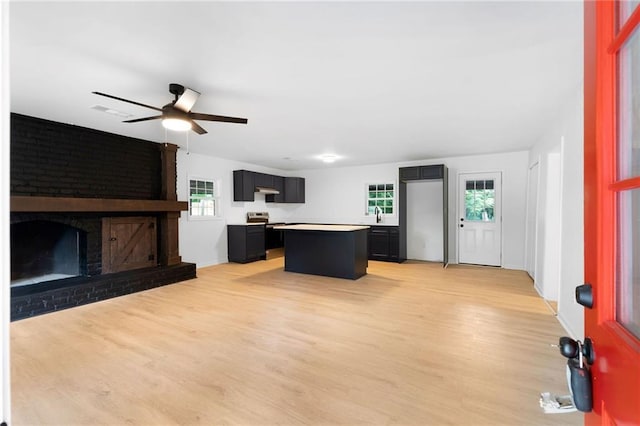 44 Crayton St, Rockmart, GA 30153 - unfurnished living room featuring light wood finished floors, ceiling fan, plenty of natural light, and a sink