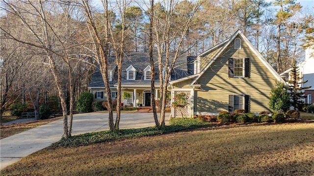 new england style home with a front lawn