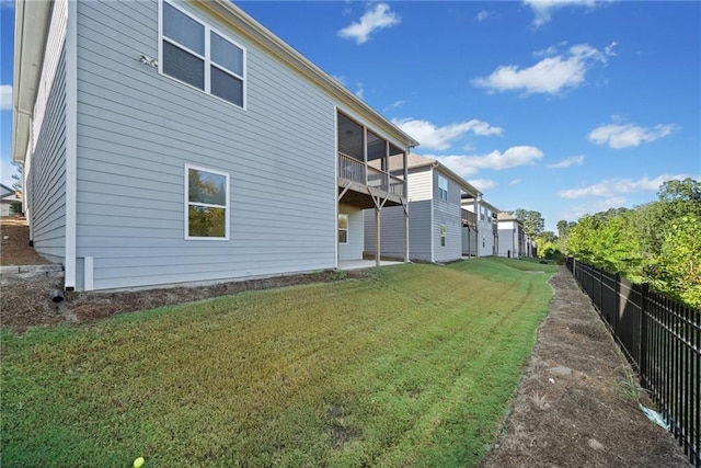 rear view of property featuring a yard