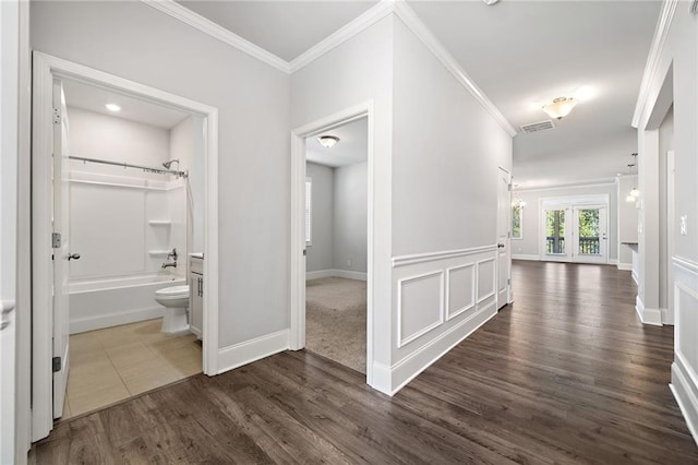 hall with dark hardwood / wood-style floors, crown molding, and french doors