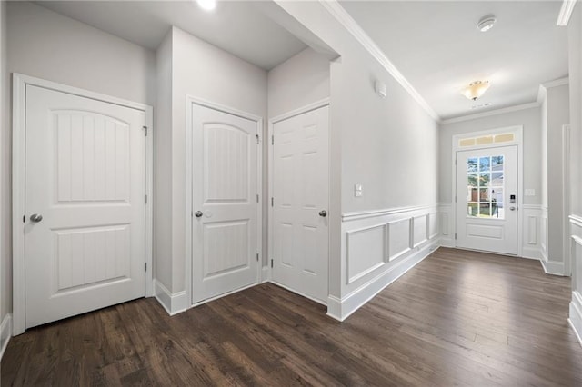 entrance foyer featuring crown molding and dark wood-type flooring