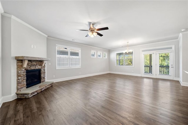 unfurnished living room featuring a fireplace, dark hardwood / wood-style floors, ceiling fan with notable chandelier, and ornamental molding