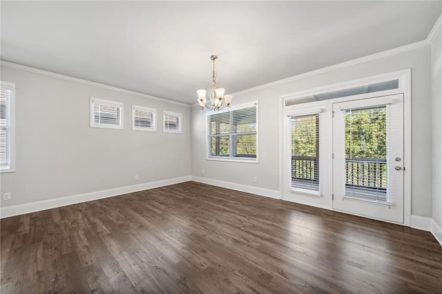 unfurnished dining area featuring dark hardwood / wood-style flooring, crown molding, and a chandelier