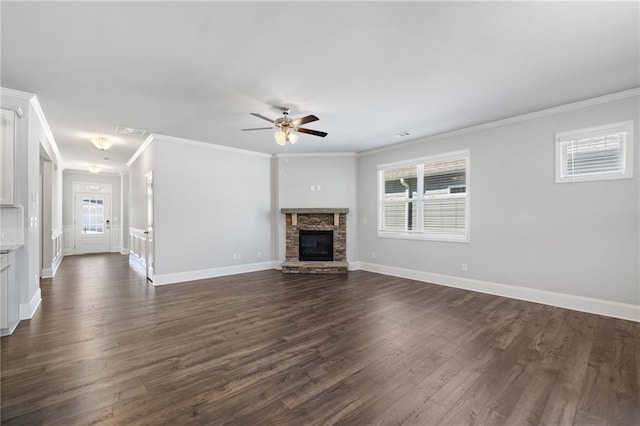 unfurnished living room with a stone fireplace, crown molding, plenty of natural light, and ceiling fan