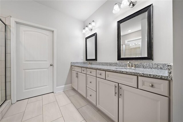 bathroom featuring vanity, tile patterned floors, and walk in shower