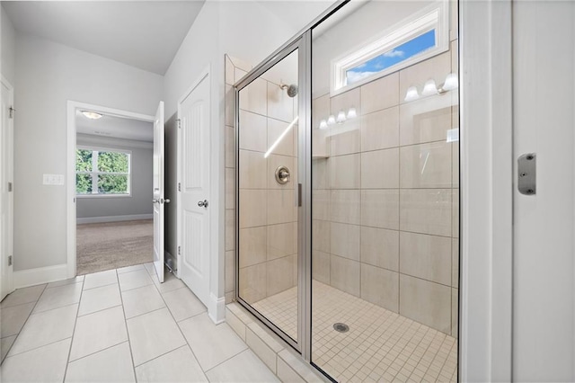 bathroom featuring tile patterned floors and a shower with shower door