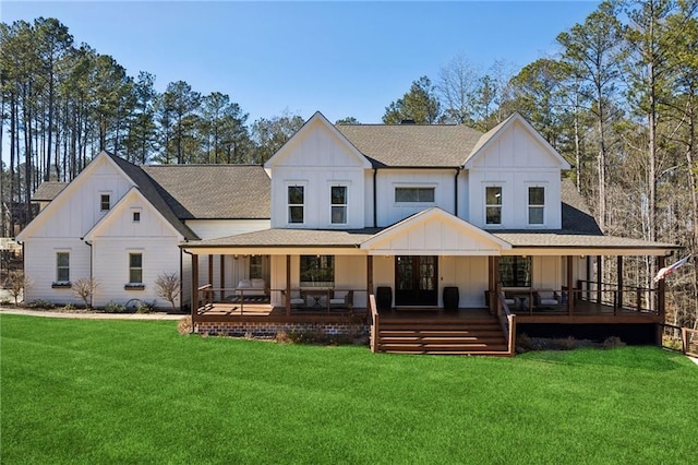 rear view of property with a porch and a yard