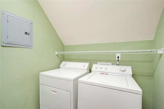 clothes washing area featuring electric panel, laundry area, and separate washer and dryer