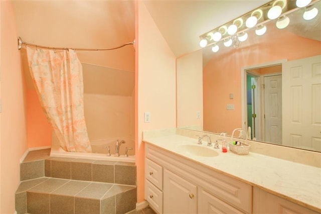 bathroom with curtained shower, tiled tub, and vanity