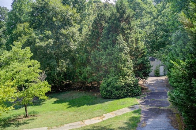 exterior space featuring a wooded view and sidewalks