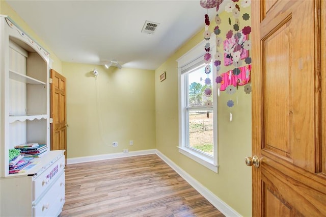 interior space with visible vents, baseboards, and light wood-style floors