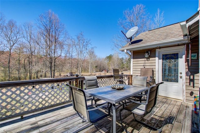 wooden terrace with outdoor dining area