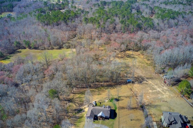 birds eye view of property featuring a wooded view