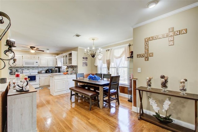 dining space featuring visible vents, baseboards, ornamental molding, ceiling fan with notable chandelier, and light wood-style floors