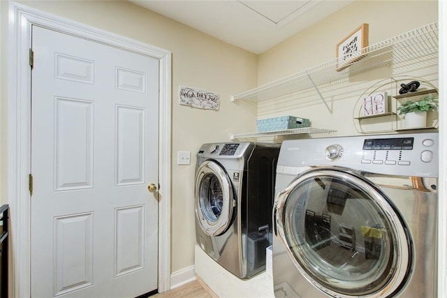 laundry area featuring washer and clothes dryer, laundry area, and baseboards