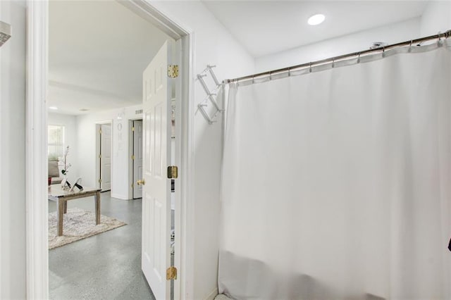 bathroom with a shower with shower curtain and recessed lighting