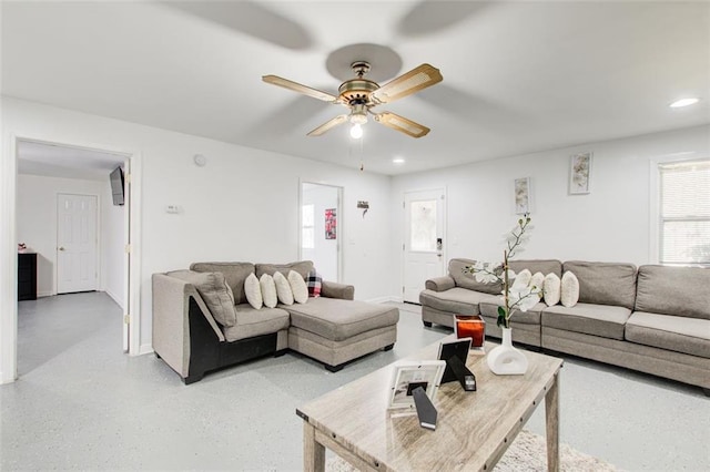 living area with recessed lighting, baseboards, and a ceiling fan