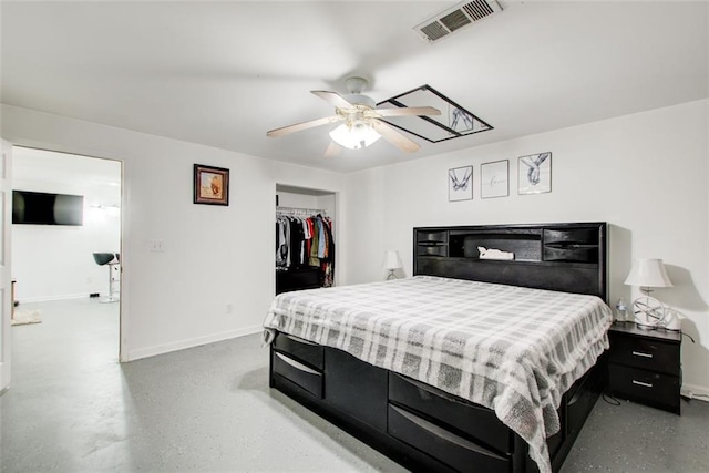 bedroom featuring visible vents, a walk in closet, a closet, baseboards, and ceiling fan