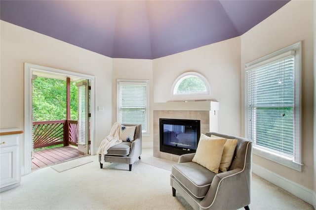 sitting room featuring a fireplace, carpet flooring, a healthy amount of sunlight, and baseboards