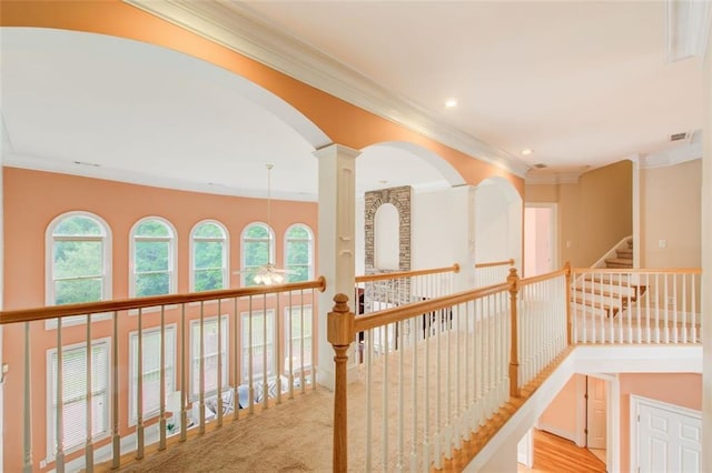 corridor with recessed lighting, decorative columns, and crown molding