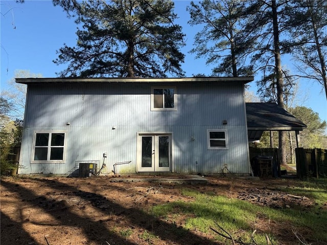 rear view of property featuring french doors and central AC