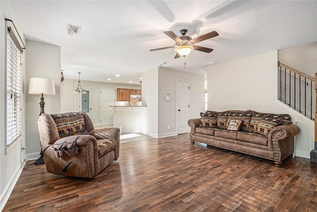 living room featuring dark hardwood / wood-style floors and ceiling fan