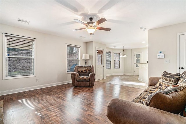 living room featuring dark hardwood / wood-style floors and ceiling fan