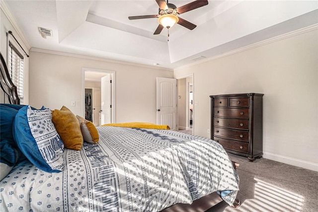 carpeted bedroom featuring crown molding, ceiling fan, and a raised ceiling