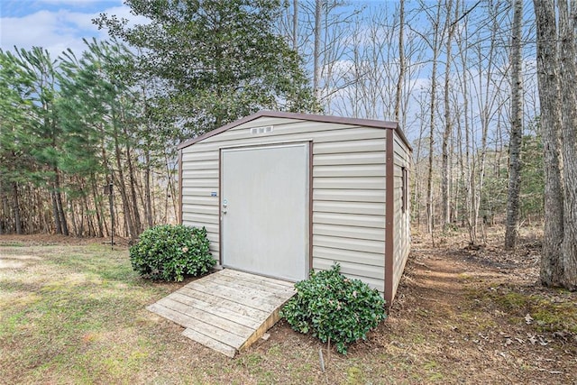 view of outbuilding featuring a lawn