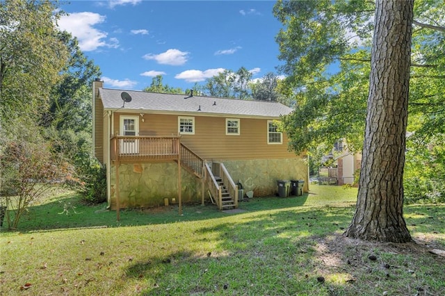 back of house featuring a yard and a wooden deck