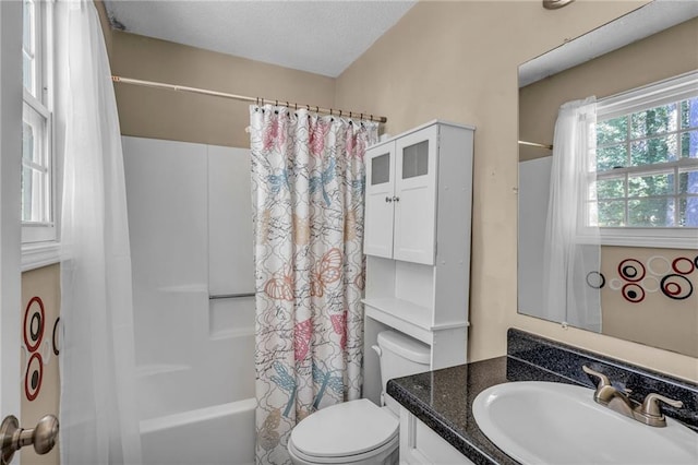 full bathroom with vanity, shower / tub combo, and toilet