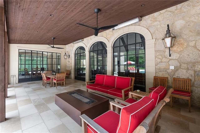 view of patio featuring outdoor dining space, an outdoor living space with a fire pit, and ceiling fan