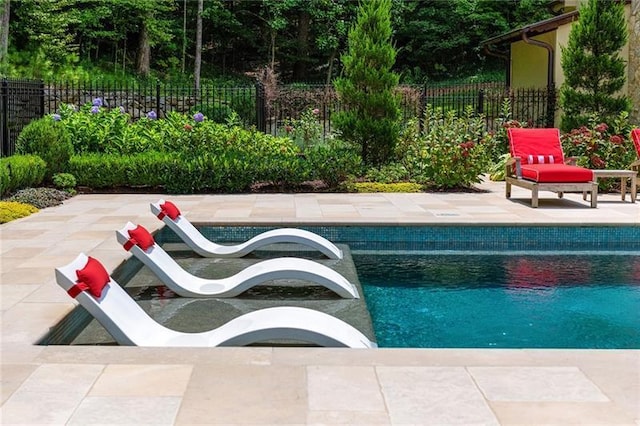 view of swimming pool with a patio area, a fenced in pool, and fence