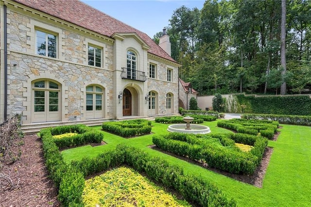 rear view of property with a yard and a chimney